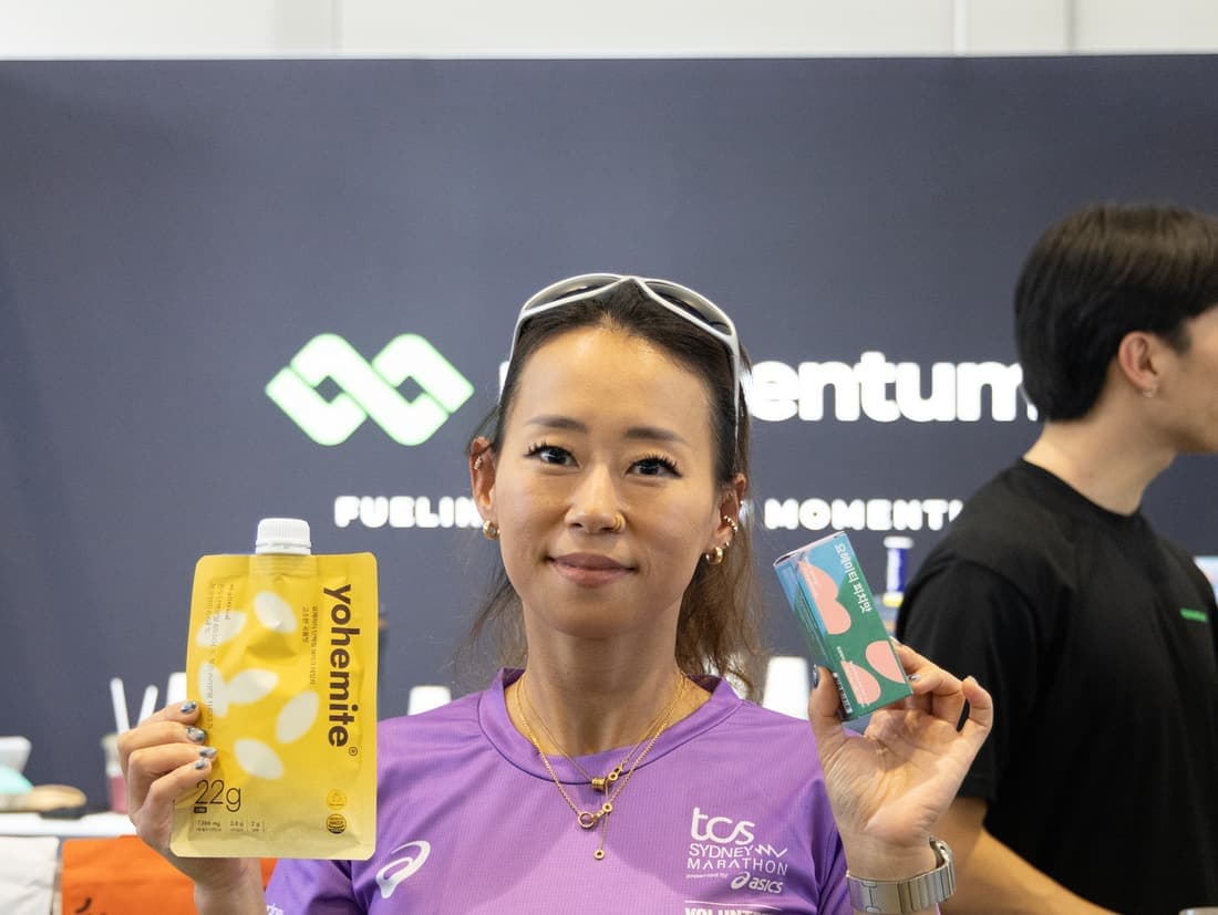 An event attendee holding product from the stand